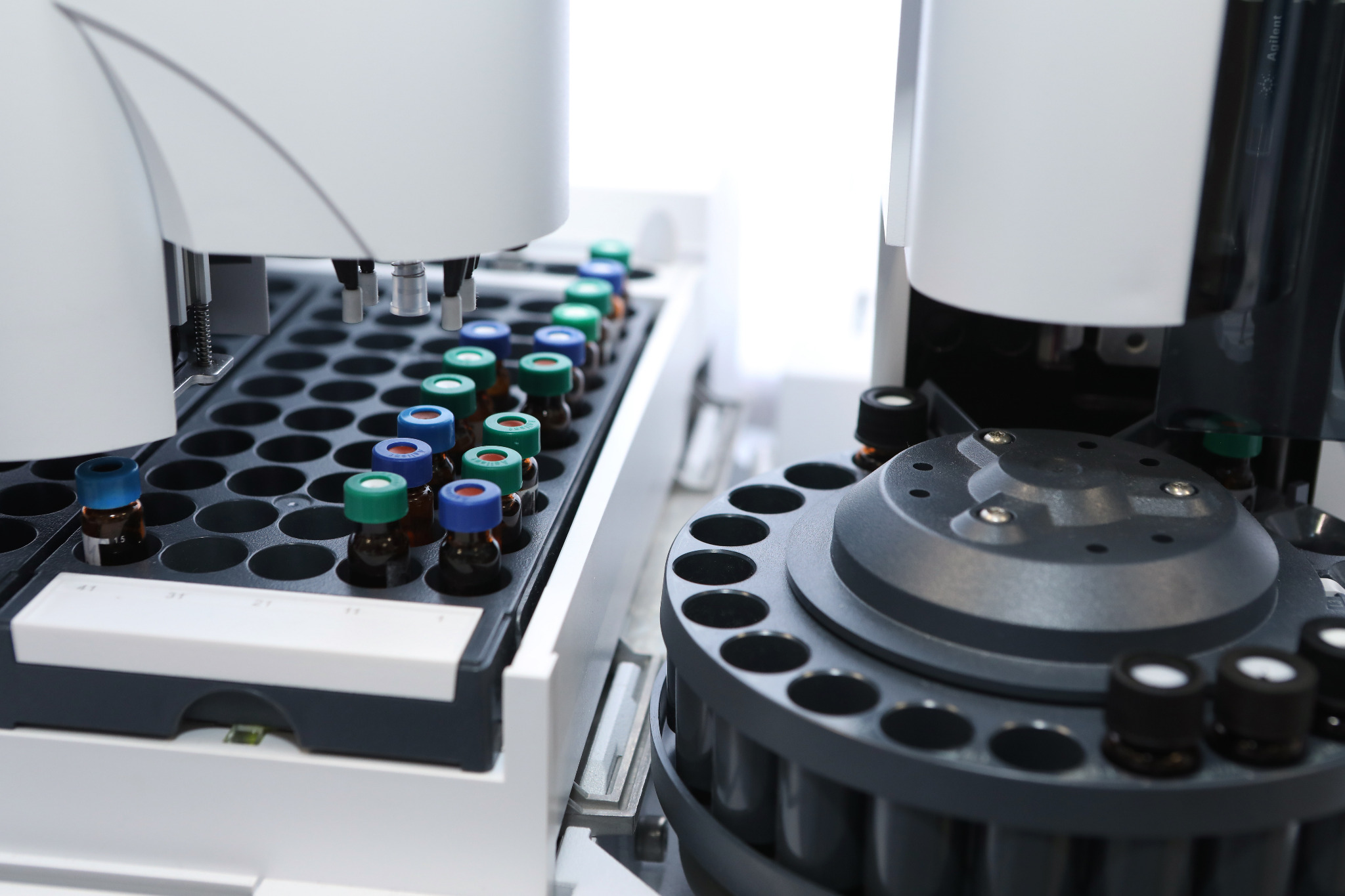 Analytical laboratory equipment with sample vials arranged in autosampler trays